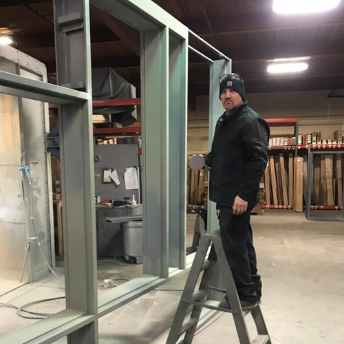 Technician performing hollow metal door repair in Glenwood Springs business