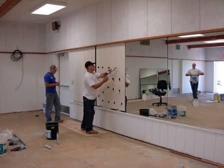 Professional installation of custom gym mirrors in a home gym or commercial fitness center in Grand Junction Colorado.