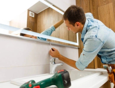 Bathroom mirror installation in Grand Junction by Summit Glass technician
