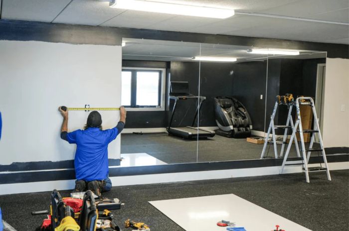Professional installation of custom gym mirrors in a home gym or fitness center in Glenwood Springs Colorado.