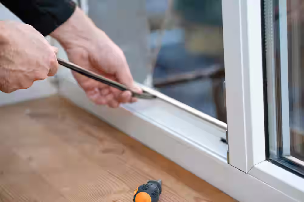 Professional technician performing same-day glass door repair on a commercial storefront door in Glenwood Springs Colorado.