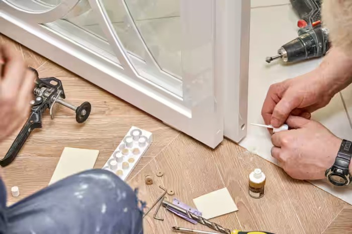 Professional technician performing same-day glass door repair on a commercial storefront door in Grand Junction Colorado.