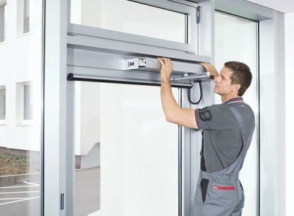 Technician performing professional door maintenance on residential and commercial doors in Rifle Colorado.
