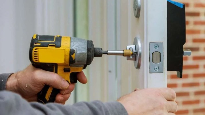 Technician repairing door hardware in Grand Junction