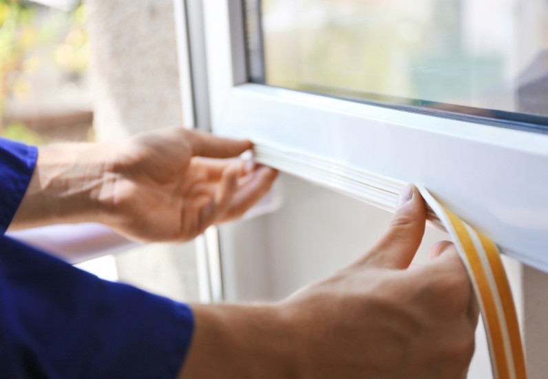 Technician repairing a window that won't stay open in Grand Junction, Colorado.