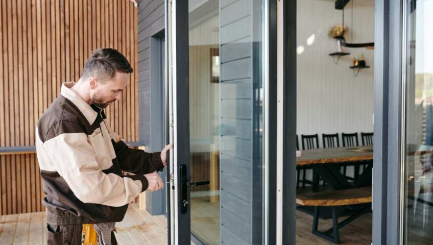 Technician performing commercial door service in Grand Junction