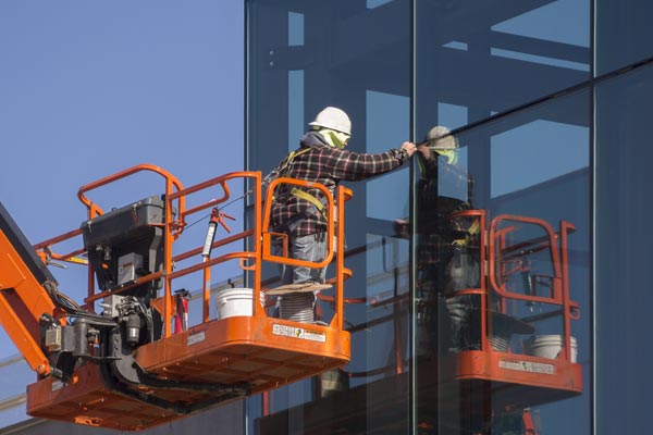 Technician replacing tempered glass in a commercial building in Grand Junction