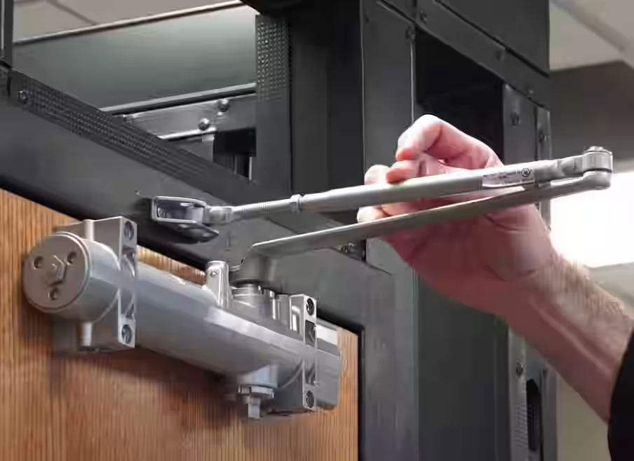 Leaking commercial door closer being repaired in Grand Junction
