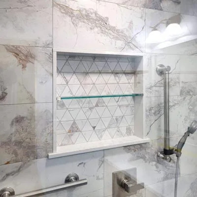 Custom glass shelf installed inside a modern shower in Glenwood Springs, Colorado.