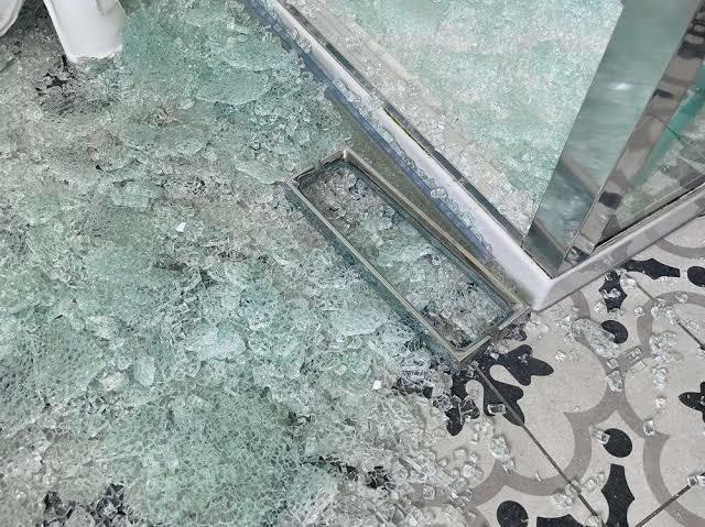 Shattered tempered glass shower door requiring professional replacement in Glenwood Springs, Colorado.
