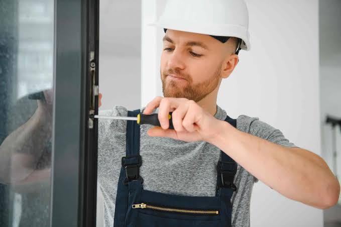Professional technician repairing an automatic commercial door in Grand Junction, Colorado.