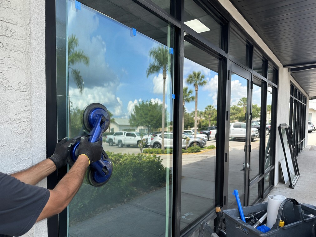 Professional glass technician repairing commercial storefront glass in Glenwood Springs, Colorado.