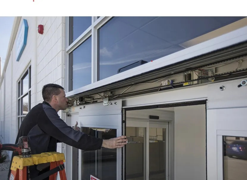 Technician inspecting an automatic commercial door that will not close in Grand Junction, Colorado.