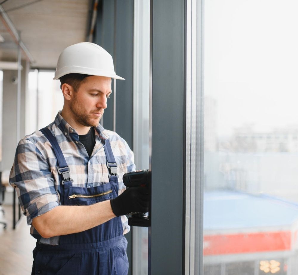 Professional technician repairing an automatic commercial door in Glenwood Springs, Colorado.