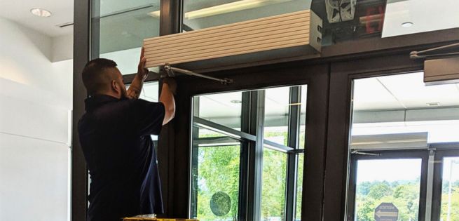 Technician inspecting an automatic commercial door that will not open in Grand Junction, Colorado.