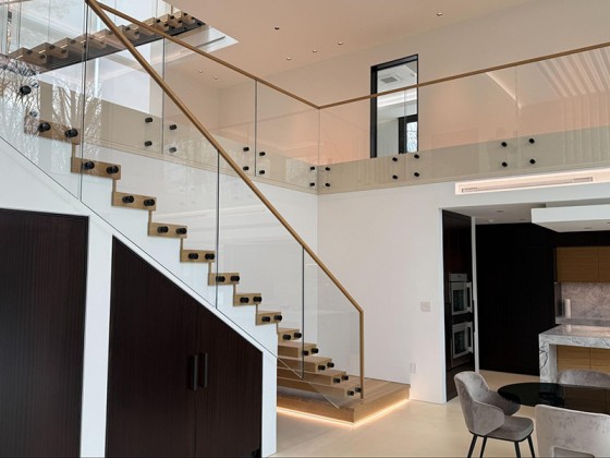 Custom glass hand rail installed on a staircase in Grand Junction, Colorado.