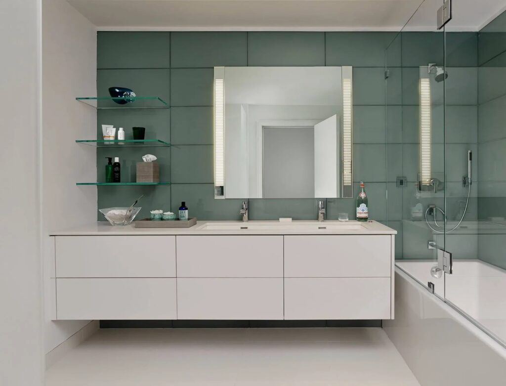 Custom glass shelves installed in a modern bathroom in Grand Junction, Colorado.